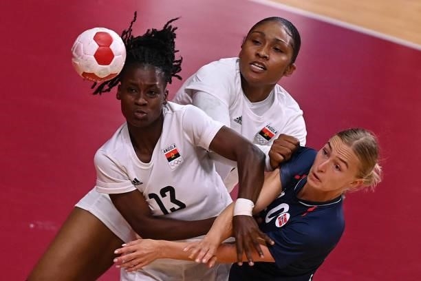 Norway's centre back Stine Bredal Oftedal is challenged by Angola's right wing Natalia Fonseca during the women's preliminary round group A handball...