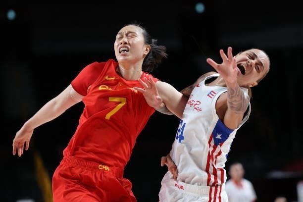 China's Shao Ting and Puerto Rico's Jazmon Gwathmey fight for a position during the women's preliminary round group C basketball match between China...