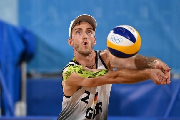 Germany's Clemens Wickler returns the ball in their men's preliminary beach volleyball pool F match between Germany and Poland during the Tokyo 2020...