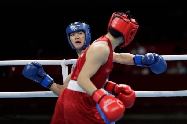 Thailand's Baison Manikon and China's Gu Hong fight during their women's welter preliminaries round of 16 boxing match during the Tokyo 2020 Olympic...