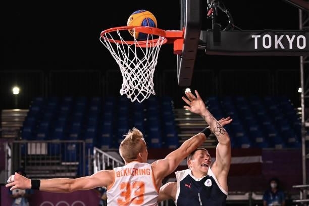 Netherlands' Ross Bekkering and Russia's Stanislav Sharov fight for the ball to score a basket during the men's quarter final 3x3 basketball match...