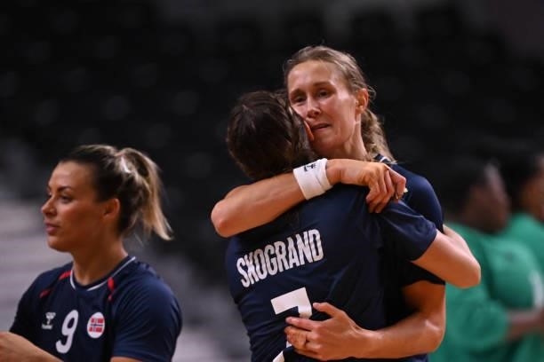 Norway's pivot Marit Malm Frafjord and teammates celebrate their victory after the women's preliminary round group A handball match between Angola...