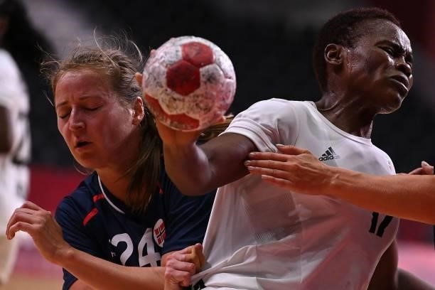 Norway's left wing Sanna Solberg Isaksen challenges Angola's right back Wuta Dombaxi during the women's preliminary round group A handball match...