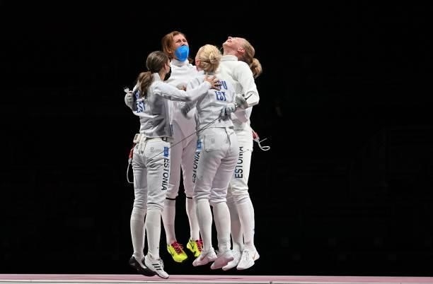 Estonia's fencers celebrate after winning against South Korea's in the womens team epee gold medal bout during the Tokyo 2020 Olympic Games at the...