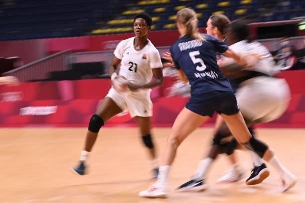 Angola's left back Magda Cazanga is challenged during the women's preliminary round group A handball match between Angola and Norway of the Tokyo...