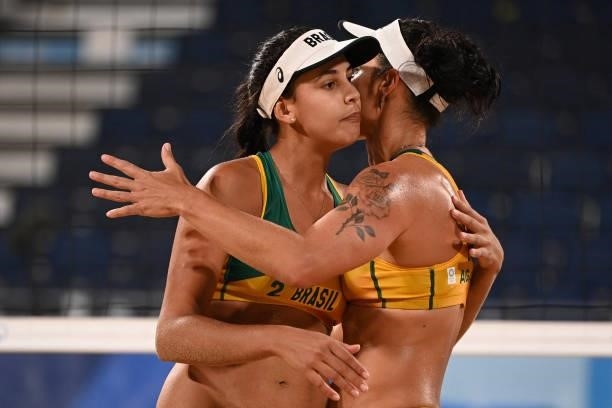 Brazil's Eduarda Santos Lisboa celebrates a point with Brazil's Agatha Bednarczuk during their women's preliminary beach volleyball pool C match...