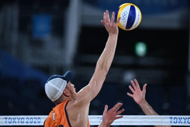 Netherlands' Alexander Brouwer attempts a shot in their men's preliminary beach volleyball pool D match between the Netherlands and Argentina during...