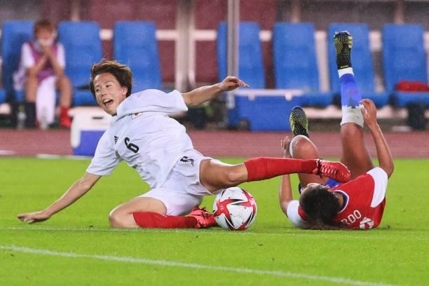 Japan's midfielder Hina Sugita is tackled by Chile's defender Daniela Pardo during the Tokyo 2020 Olympic Games women's group E first round football...