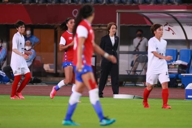 Japan's coach Asako Takakura gives instructions to players from the touchline during the Tokyo 2020 Olympic Games women's group E first round...