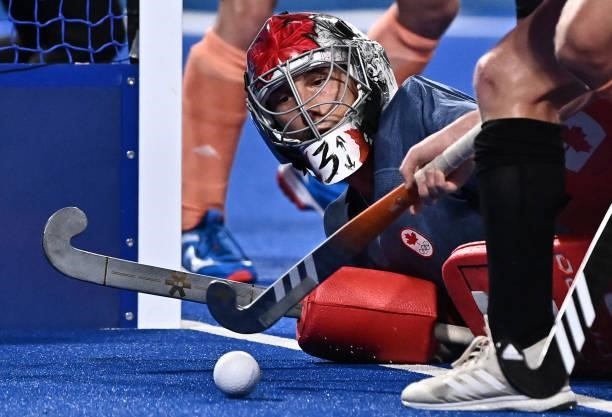 Canada's goalkeeper Antoni Pawel Kindler eyes the ball during the men's pool B match of the Tokyo 2020 Olympic Games field hockey competition against...