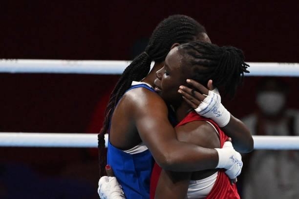 Kenya's Elizabeth Akinyi and Mozambique's Acinda Helena Panguana hug at the end of their women's welter preliminaries round of 16 boxing match during...