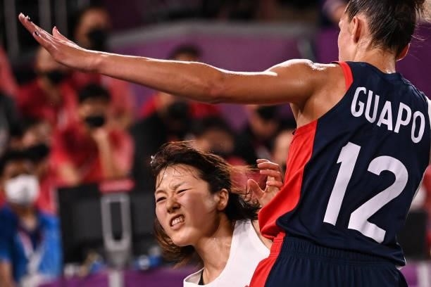 Japan's Mai Yamamoto fights for the ball with France's Laetitia Guapo during the women's quarter final 3x3 basketball match between Japan and France...