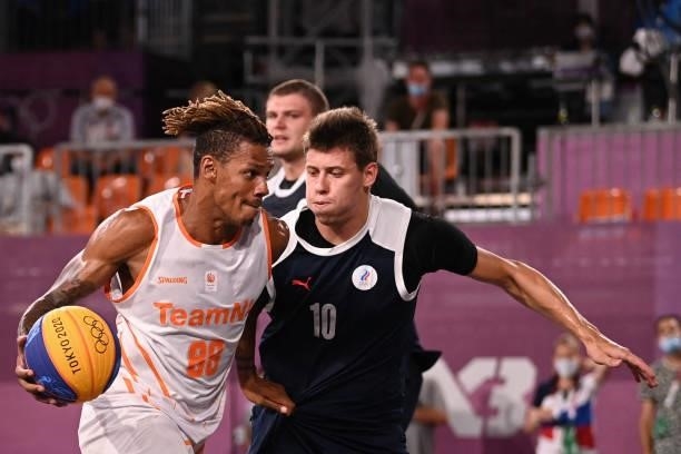 Netherlands' Jessey Voorn fights for the ball with Russia's Kirill Pisklov during the men's quarter final 3x3 basketball match between Netherlands...