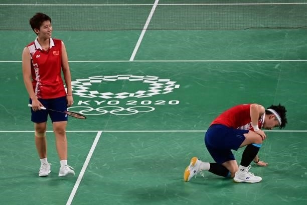 China's Li Yinhui and China's Du Yue reacts after a point in their women's doubles badminton group stage match against South Korea's Lee So-hee and...