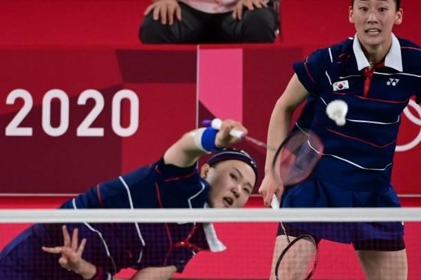 South Korea's Lee So-hee watches South Korea's Shin Seung-chan hit a shot in their women's doubles badminton group stage match against China's Li...