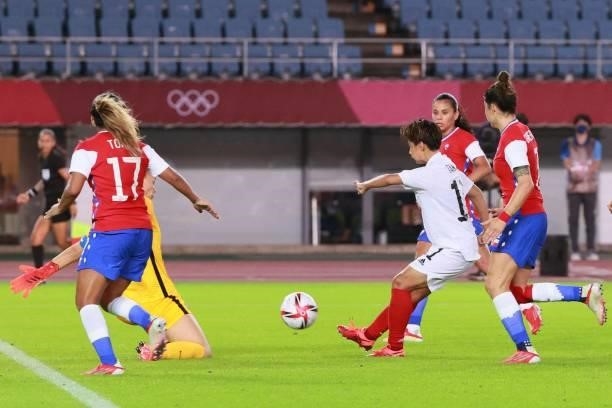 Japan's forward Mina Tanaka shoots and scores a goal during the Tokyo 2020 Olympic Games women's group E first round football match between Chile and...