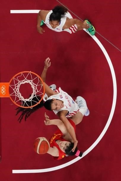 China's Li Yueru goes to the basket past a Puerto Rico player in the women's preliminary round group C basketball match between China and Puerto Rico...