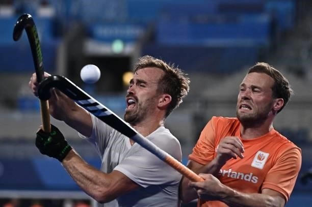 Canada's Gordon Mackenzi Johnston and Netherlands' Roel Bovendeert vie for the ball during their men's pool B match of the Tokyo 2020 Olympic Games...