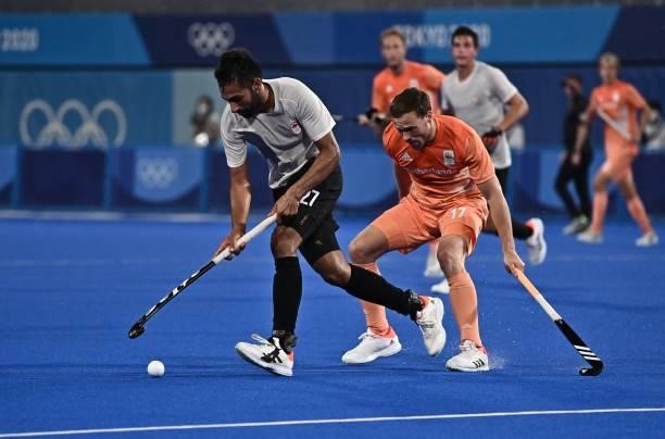 Canada's Sukhpal Singh Panesar dribbled the ball past Netherlands' Roel Bovendeert during their men's pool B match of the Tokyo 2020 Olympic Games...
