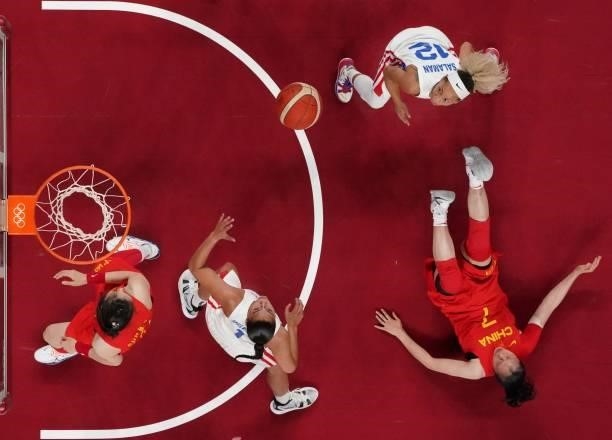 Puerto Rico's Tayra Melendez looks at the ball as China's Shao Ting falls on the court during the women's preliminary round group C basketball match...