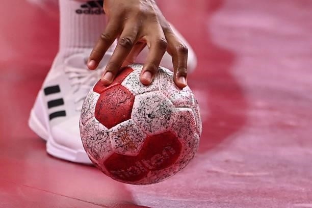 Handball player grabs the ball during the women's preliminary round group A handball match between Angola and Norway of the Tokyo 2020 Olympic Games...