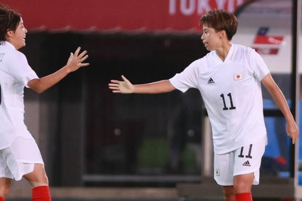 Japan's forward Mina Tanaka celebrates with a teammate after scoring a goal during the Tokyo 2020 Olympic Games women's group E first round football...