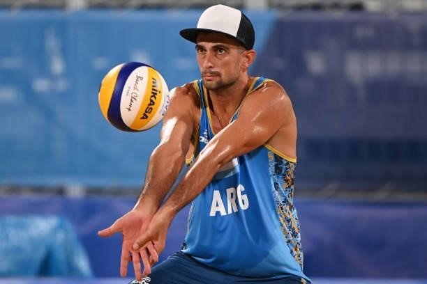 Argentina's Julian Amado Azaad plays a shot during their men's preliminary beach volleyball pool D match between the Netherlands and Argentina during...