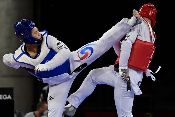 South Korea's In Kyo-don and Slovenia's Ivan Konrad Trajkovic compete in the taekwondo men's +80kg bronze medal A bout during the Tokyo 2020 Olympic...