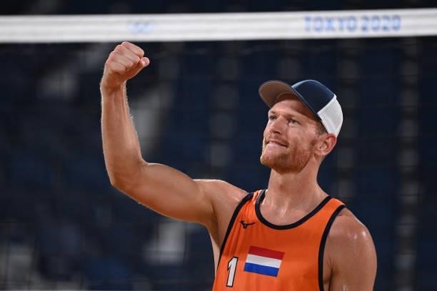 Netherlands' Alexander Brouwer celebrates their win during their men's preliminary beach volleyball pool D match between the Netherlands and...