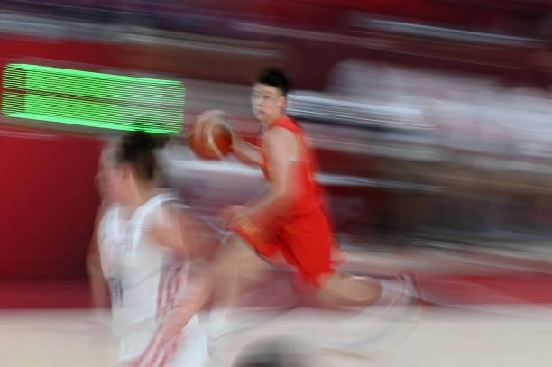 China's Huang Sijing runs with the ball in the women's preliminary round group C basketball match between China and Puerto Rico during the Tokyo 2020...