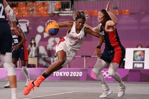 Japan's Stephanie Mawuli dribbles the ball past France's Marie-Eve Paget during the women's quarter final 3x3 basketball match between Japan and...