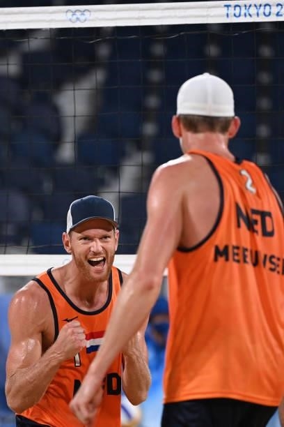Netherlands' Alexander Brouwer celebrates their win with Netherlands' Robert Meeuwsen during their men's preliminary beach volleyball pool D match...