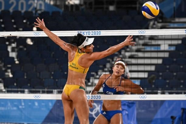 Brazil's Agatha Bednarczuk watches a shot by China's Xia Xinyi during their women's preliminary beach volleyball pool C match between Brazil and...