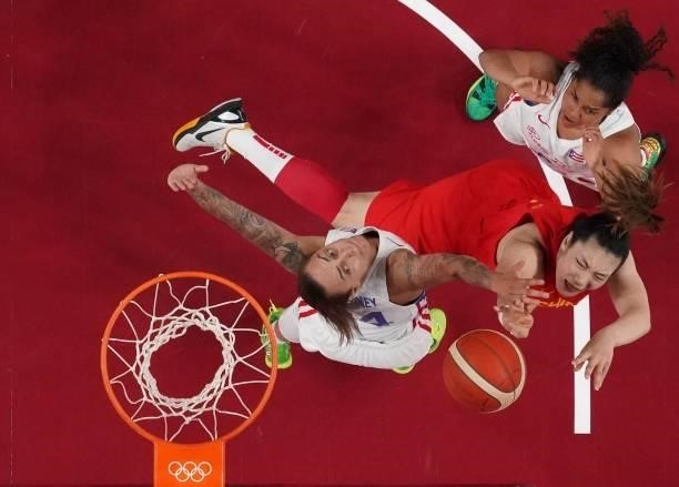 China's Wang Siyu goes to the basket past Puerto Rico's Jazmon Gwathmey in the women's preliminary round group C basketball match between China and...