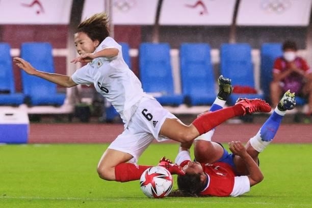 Japan's midfielder Hina Sugita is tackled by Chile's defender Daniela Pardo during the Tokyo 2020 Olympic Games women's group E first round football...