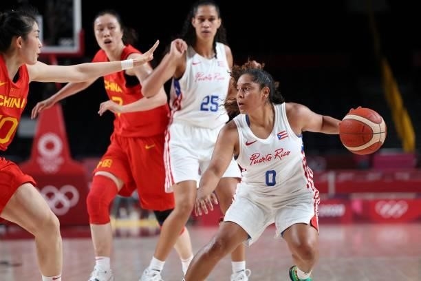 Puerto Rico's Jennifer O'neill dribbles the ball next to China's Pan Zhenqi in the women's preliminary round group C basketball match between China...