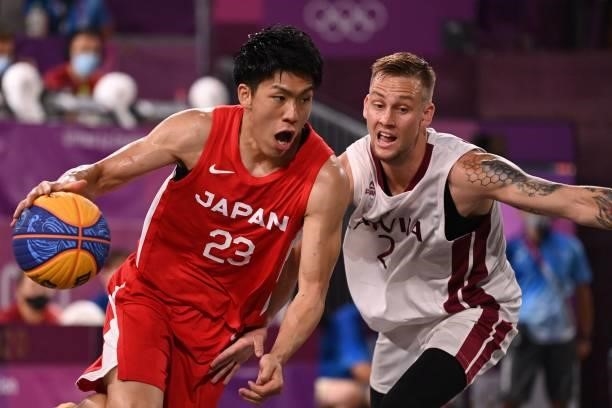 Japan's Ryuto Yasuoka dribbles the ball past Latvia's Karlis Lasmanis during the men's quarter final 3x3 basketball match between Latvia and Japan at...