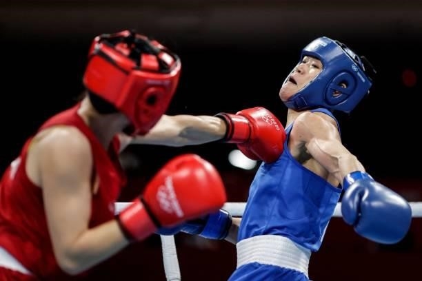 Thailand's Baison Manikon and China's Gu Hong fight during their women's welter preliminaries round of 16 boxing match during the Tokyo 2020 Olympic...