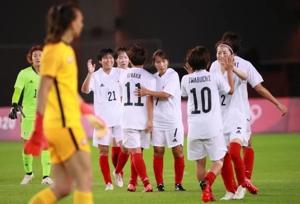 Japan players celebrate after winning the Tokyo 2020 Olympic Games women's group E first round football match between Chile and Japan at the Miyagi...