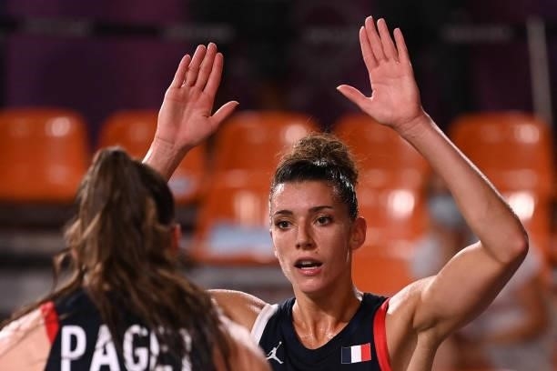 France's Marie-Eve Paget and France's Laetitia Guapo celebrate after wining at the end of the women's quarter final 3x3 basketball match between...