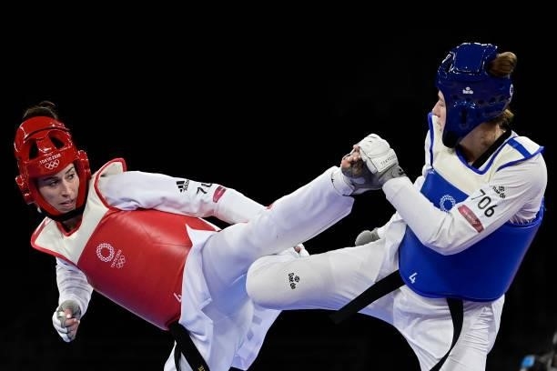 Poland's Aleksandra Kowalczuk and Britain's Bianca Walkden compete in the taekwondo women's +67kg bronze medal B bout during the Tokyo 2020 Olympic...