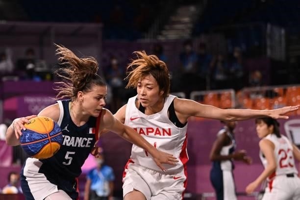 France's Marie-Eve Paget dribbles the ball past Japan's Mio Shinozaki during the women's quarter final 3x3 basketball match between Japan and France...