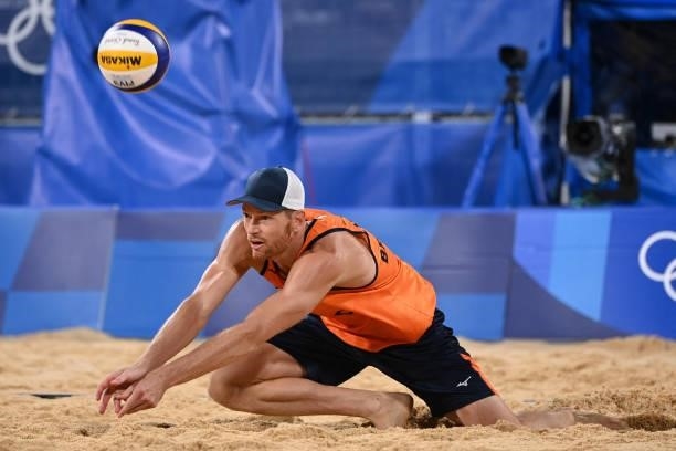 Netherlands' Alexander Brouwer hits the ball in their men's preliminary beach volleyball pool D match between the Netherlands and Argentina during...