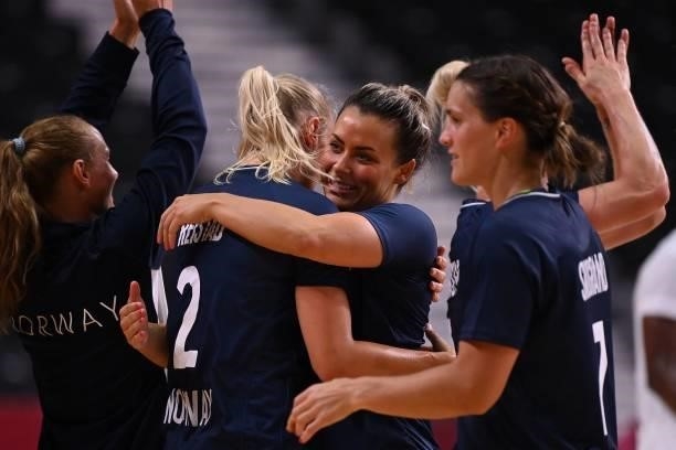 Norway's right back Nora Moerk and teammates celebrate their victory after the women's preliminary round group A handball match between Angola and...