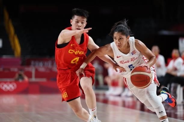 Puerto Rico's Pamela Rosado dribbles the ball past China's Li Yuan in the women's preliminary round group C basketball match between China and Puerto...