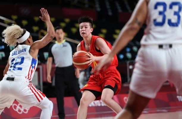China's Li Yuan goes to the basket past Puerto Rico's Dayshalee Salaman in the women's preliminary round group C basketball match between China and...