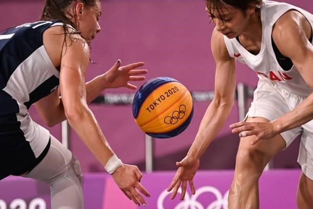 France's Marie-Eve Paget fights for the ball with Japan's Mio Shinozaki during the women's quarter final 3x3 basketball match between Japan and...