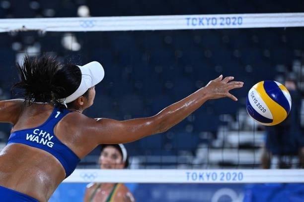China's Wang Fan reaches for the ball during their women's preliminary beach volleyball pool C match between Brazil and China during the Tokyo 2020...