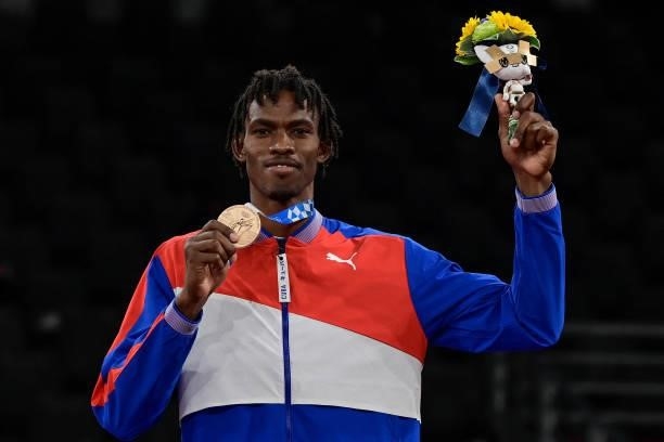 Bronze medalist Cuba's Rafael Yunier Alba Castillo pose on the podium after the the taekwondo men's +80kg medal bouts during the Tokyo 2020 Olympic...
