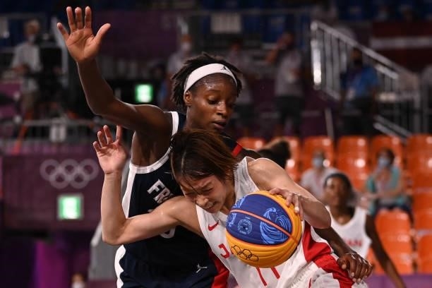 France's Mamignan Toure (L0 fights for the ball with Japan's Mio Shinozaki during the women's quarter final 3x3 basketball match between Japan and...